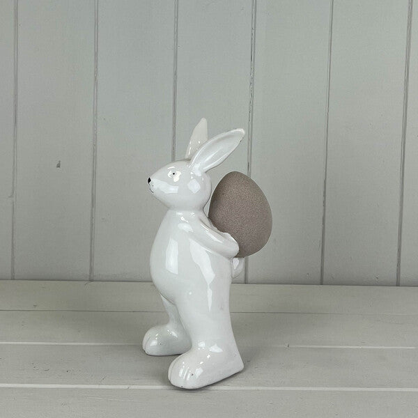 Ceramic White Rabbit holding an Egg H17.5cm W8.1cm D10.5cm Weight-289g